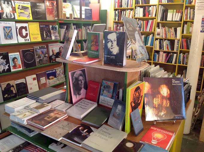 Interior of Aye-Aye Books featuring shelves filled with a variety of books. The central display showcases prominent titles and covers. © Aye-Aye Books