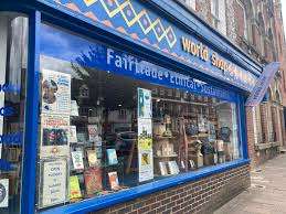 Exterior view of Reading International Support Centre's World Shop, displaying a variety of fair trade and ethical products in the window.